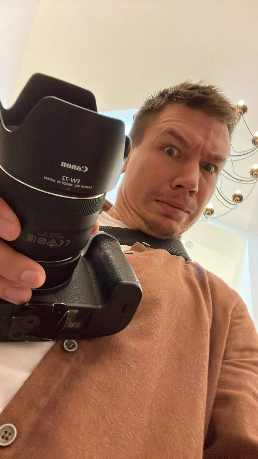 image of me with a camera, link leads to photography portfolio